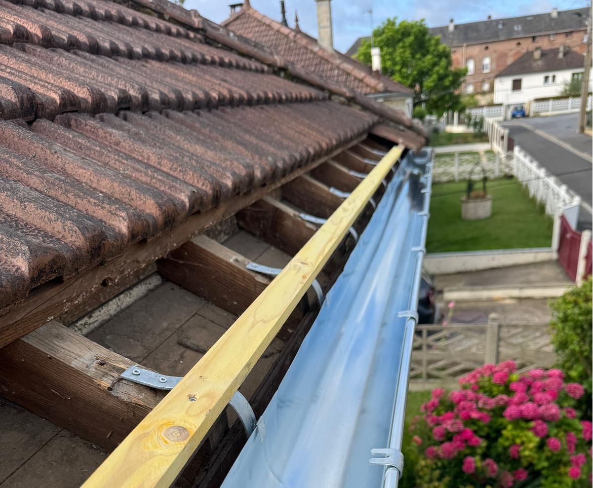The red-tiled roofs of the village create a picturesque scene against the backdrop of the cityscape, inviting travelers to explore its historic charm.